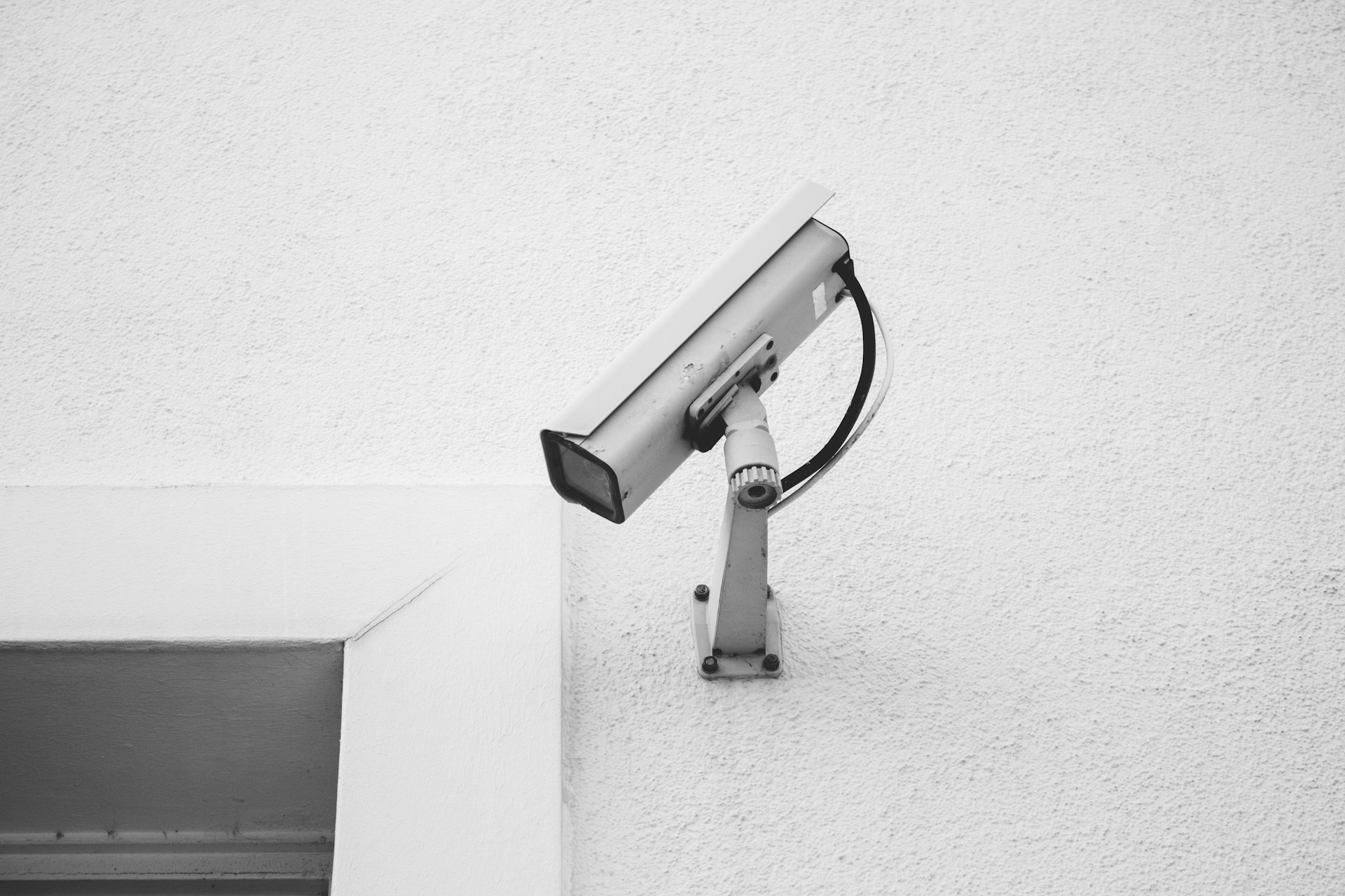 white security camera on white wall